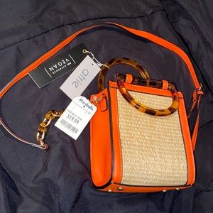 BRAND NEW WITH TAGS. Small orange bag. Optional long strap. Hand bag